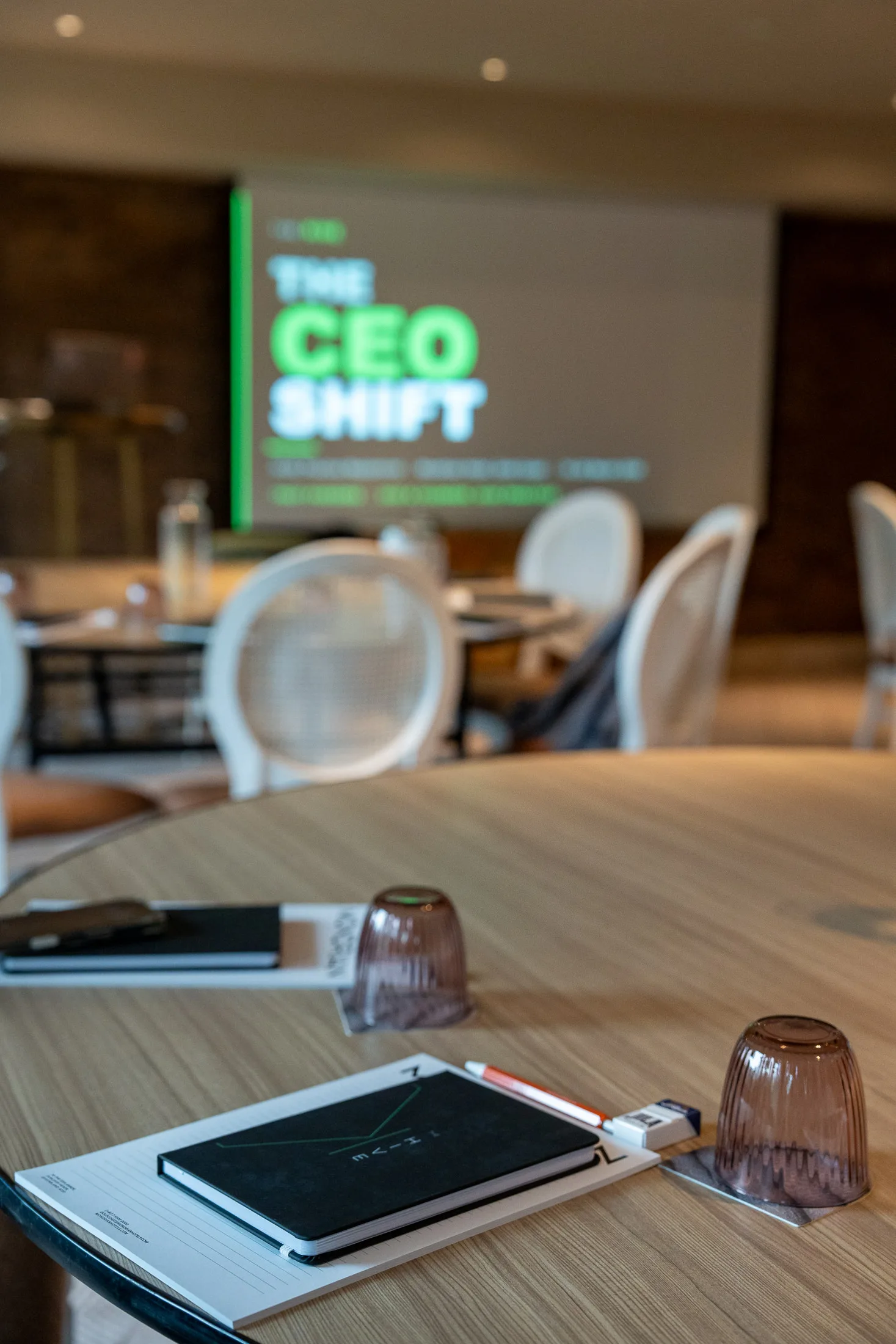 A Hive Practice coaching session with 'THE CEO SHIFT' projected on screen and a Hive workbook on the table